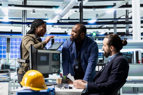 multiethnic group of factory engineers in business office