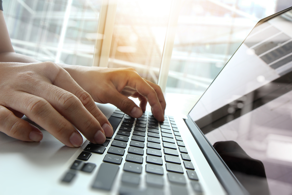 person typing on laptop